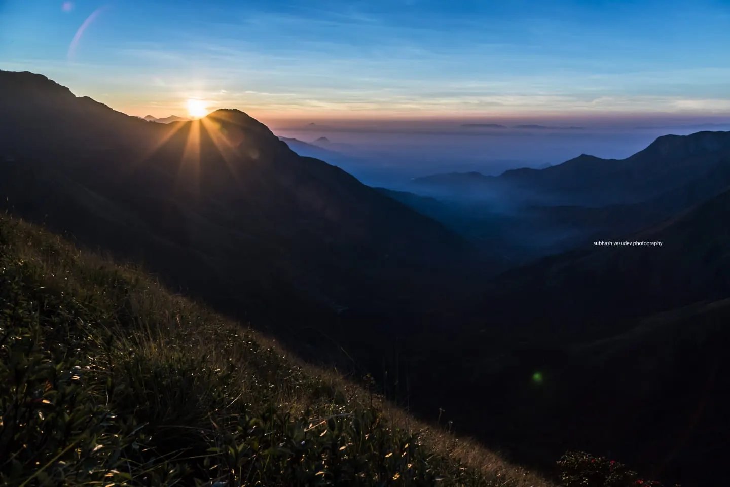 Sunrise over the valleys from Kolukkumalai near Munnar